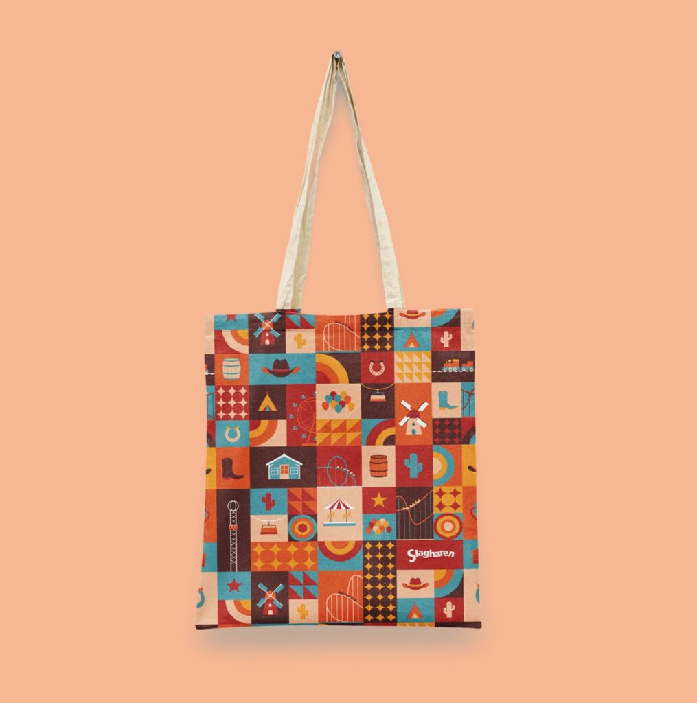 Bolsa de tela con un patrón geométrico de colores de temática western (molinos, cactus, botas) y el logotipo Slagharen